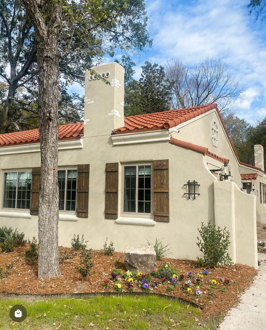 Cream colored house with brown shutters