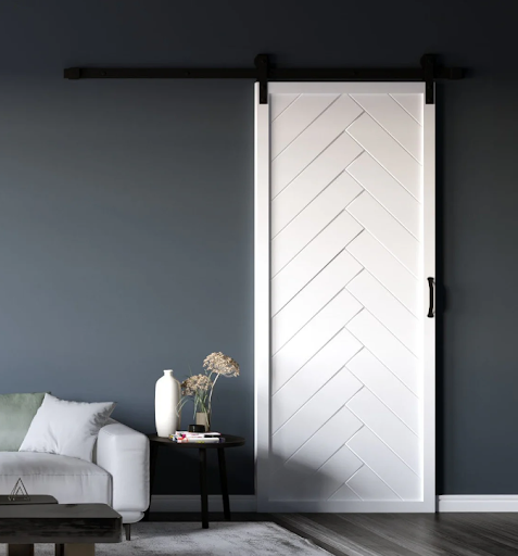 A herringbone patterned modern sliding barn door from Dogberry Collections, featuring sleek lines and contemporary design