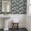 Hattie Denim peel and stick wallpaper above white beadboard in a bathroom with a pedestal sink