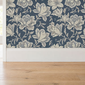 Close up of Hattie Denim canvas wallpaper meeting a white baseboard and oak floor