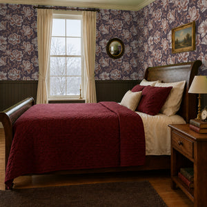 Hattie Terracotta wallpaper on two walls of a vintage bedroom with a sleigh bed