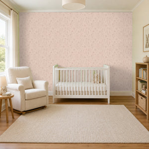 Meadow Blush peel and stick wallpaper in a nursery with a white crib and a rocking chair