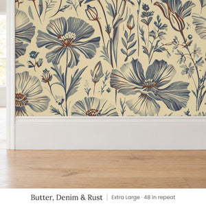 Posy Butter, Denim & Rust peel and stick wallpaper, extra large 48 in repeat, above a white baseboard and oak floor