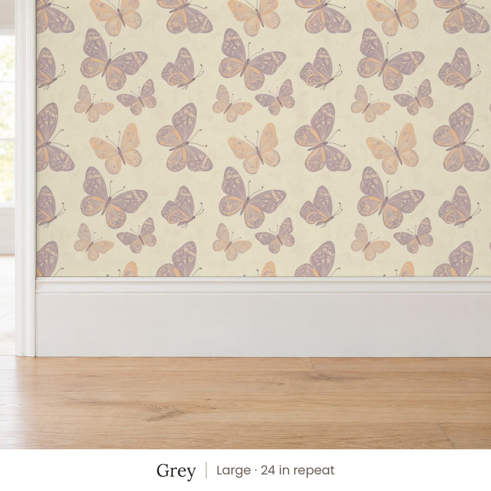 Butterfly Kisses Grey peel and stick wallpaper, large 24 in repeat, above a white baseboard and oak floor