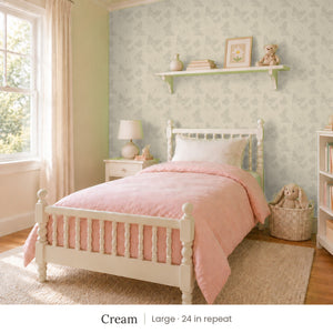 Butterfly Kisses Cream peel and stick wallpaper, large 24 in repeat, in a girl's bedroom with a white spindle bed and a pink quilt