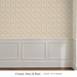 Butterfly Kisses Cream, Navy & Rust peel and stick wallpaper, small 12 in repeat, above white panel wainscoting