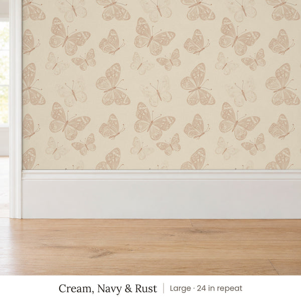 Butterfly Kisses Cream, Navy & Rust peel and stick wallpaper, large 24 in repeat, above a white baseboard and oak floor