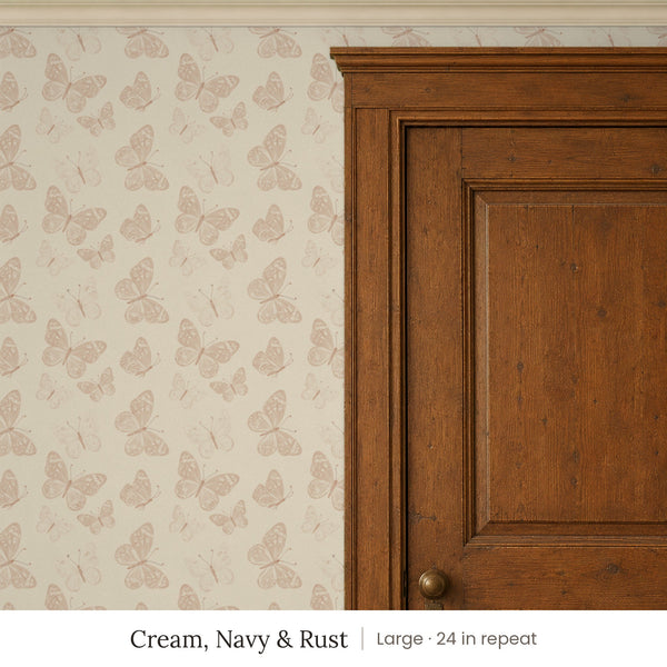 Butterfly Kisses Cream, Navy & Rust peel and stick wallpaper, large 24 in repeat, beside a wood door