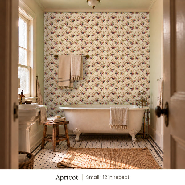 Olivia Apricot peel and stick wallpaper, small 12 in repeat, in a bathroom with a clawfoot tub and a towel bar