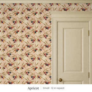 Olivia Apricot peel and stick wallpaper, small 12 in repeat, beside a cream paneled door