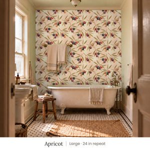 Olivia Apricot peel and stick wallpaper, large 24 in repeat, in a bathroom with a clawfoot tub and a towel bar
