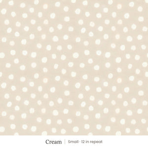 Nellie wallpaper in Cream, small 12 in repeat, soft painted cream dots on a sand ground