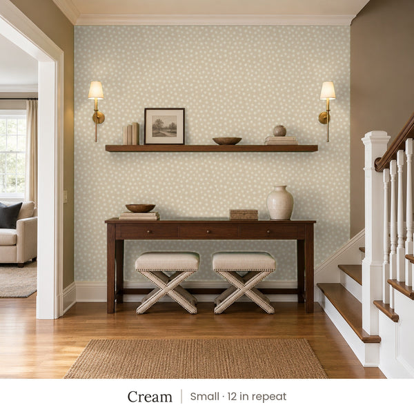 Nellie Cream peel and stick wallpaper, small 12 in repeat, in an entry with a wood console and a staircase