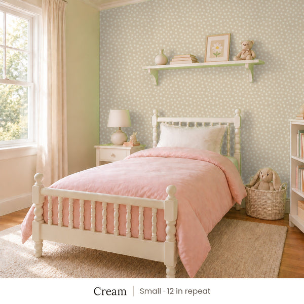 Nellie Cream peel and stick wallpaper, small 12 in repeat, in a girl's bedroom with a white spindle bed and a pink quilt