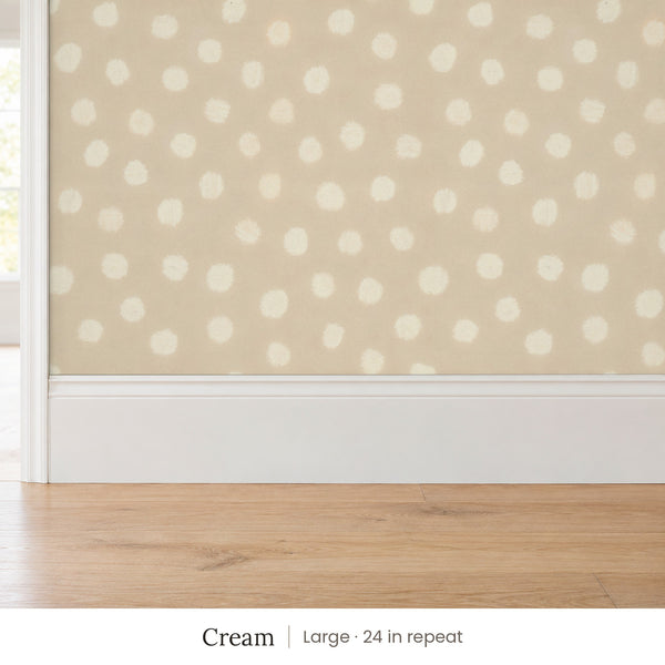 Nellie Cream peel and stick wallpaper, large 24 in repeat, above a white baseboard and oak floor