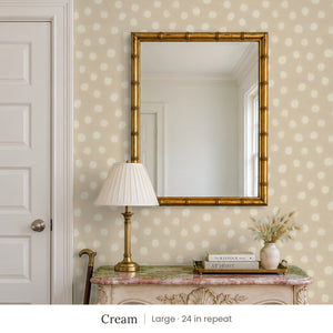 Nellie Cream peel and stick wallpaper, large 24 in repeat, in an entry with a gold mirror and a painted console