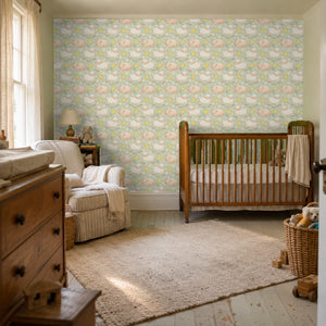 Night Night Sage peel and stick wallpaper in a nursery with a wood crib and an armchair