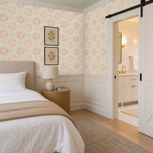 Rosie Blush peel and stick wallpaper in a bedroom with white wainscoting and a barn door