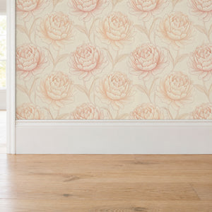 Rosie Blush peel and stick wallpaper above a white baseboard and oak floor