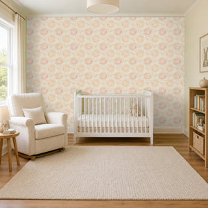 Rosie Blush peel and stick wallpaper in a nursery with a white crib and a rocking chair