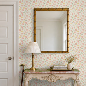 Marguerite Cream peel and stick wallpaper in an entry with a gold mirror and a carved console