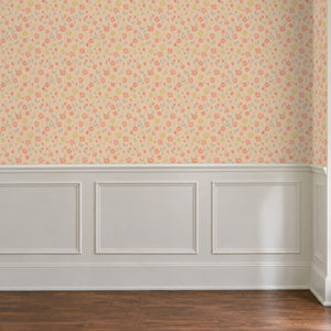 Marguerite Apricot peel and stick wallpaper above white panel wainscoting