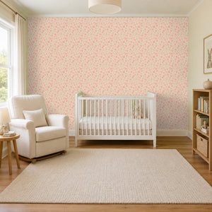 Marguerite Rosebud peel and stick wallpaper in a nursery with a white crib and an armchair