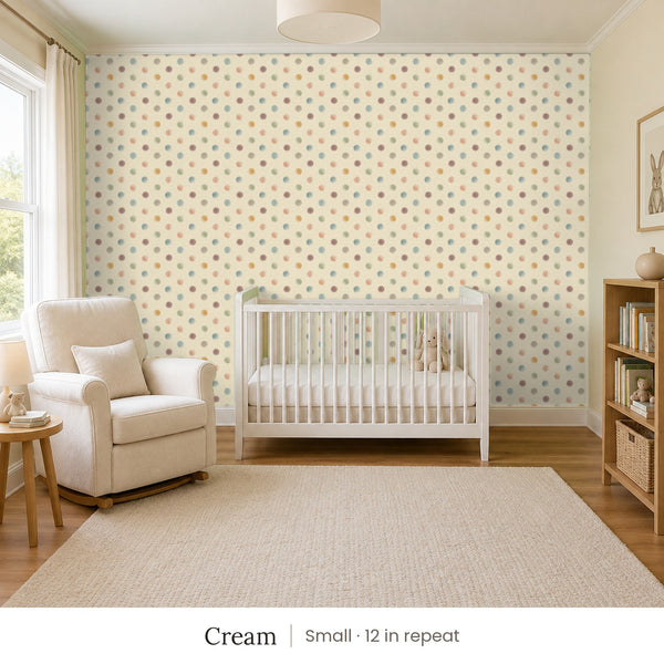 Celia Cream peel and stick wallpaper, small 12 in repeat, in a nursery with a white crib and an armchair