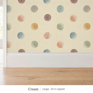 Celia Cream peel and stick wallpaper, large 24 in repeat, above a white baseboard and oak floor