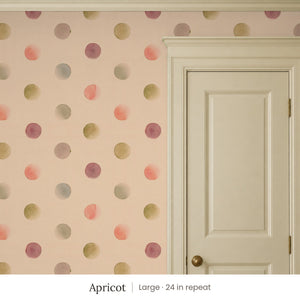 Celia Apricot peel and stick wallpaper, large 24 in repeat, beside a cream panel door