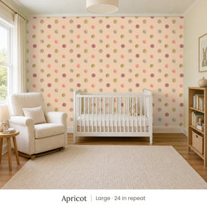 Celia Apricot peel and stick wallpaper, large 24 in repeat, in a nursery with a white crib and an armchair
