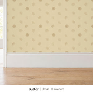 Celia Butter peel and stick wallpaper, small 12 in repeat, above a white baseboard and oak floor