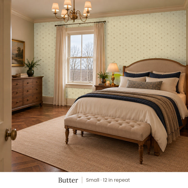 Celia Butter peel and stick wallpaper, small 12 in repeat, in a bedroom with an upholstered bed and a tufted bench