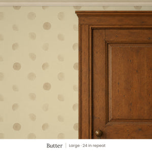 Celia Butter peel and stick wallpaper, large 24 in repeat, beside a dark wood panel door