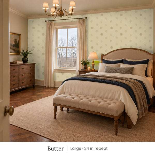 Celia Butter peel and stick wallpaper, large 24 in repeat, in a bedroom with an upholstered bed and a tufted bench
