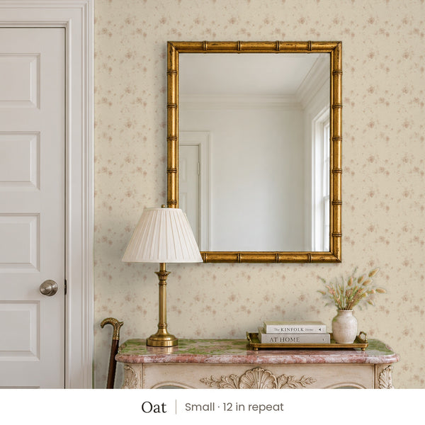 Ashwell Oat peel and stick wallpaper, small 12 in repeat, in an entry with a gold mirror and a carved console