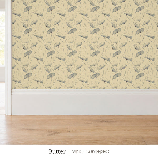 Zelda Butter peel and stick wallpaper, small 12 in repeat, above a white baseboard and oak floor