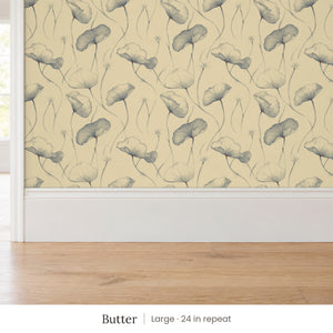 Zelda Butter peel and stick wallpaper, large 24 in repeat, above a white baseboard and oak floor