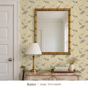 Zelda Butter peel and stick wallpaper, large 24 in repeat, in an entry with a gold mirror and a carved console