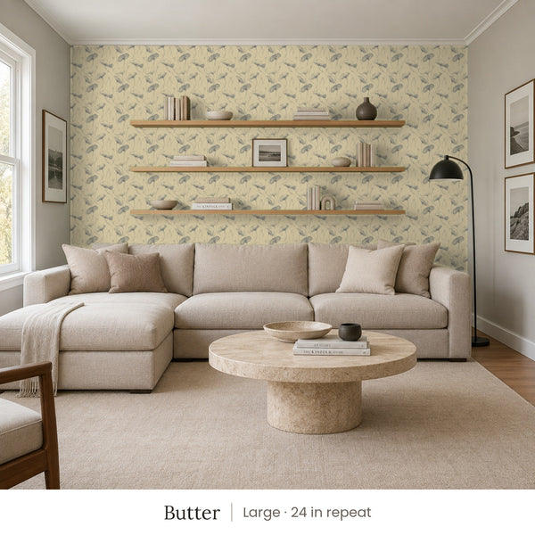 Zelda Butter peel and stick wallpaper, large 24 in repeat, in a family room with a sectional sofa and open shelves