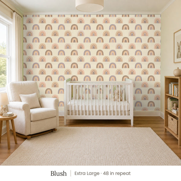 Over the Rainbow Blush peel and stick wallpaper, extra large 48 in repeat, in a nursery with a white crib and an armchair