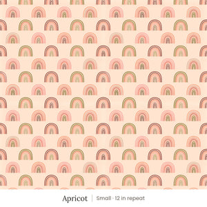 Over the Rainbow wallpaper in Apricot, small 12 in repeat, pink, coral and olive rainbows on peach