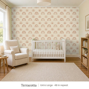 Over the Rainbow Terracotta peel and stick wallpaper, extra large 48 in repeat, in a nursery with a white crib and an armchair