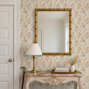 Pippa Clay peel and stick wallpaper in an entry with a gold mirror and a carved console