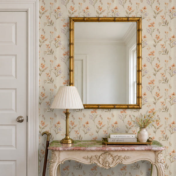 Pippa Clay peel and stick wallpaper in an entry with a gold mirror and a carved console