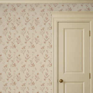 Pippa Rose peel and stick wallpaper beside a cream panel door