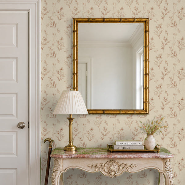 Pippa Rose peel and stick wallpaper in an entry with a gold mirror and a carved console