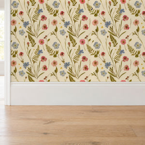 Cecily Meadow peel and stick wallpaper above a white baseboard and oak floor