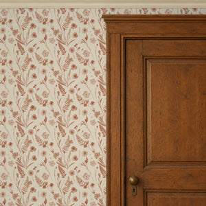 Cecily Terracotta peel and stick wallpaper beside a dark wood panel door