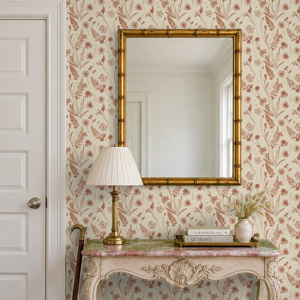 Cecily Terracotta peel and stick wallpaper in an entry with a gold mirror and a carved console